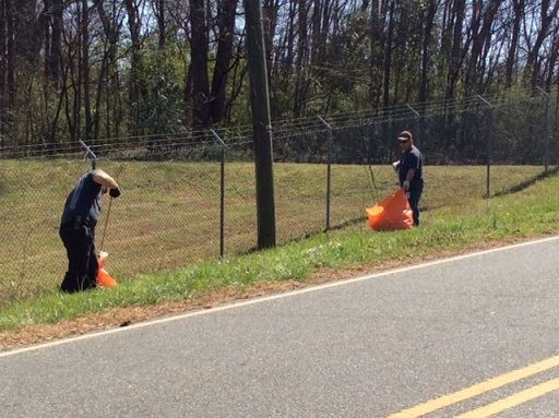 People Picking Up Garbage from the Barrow Pit