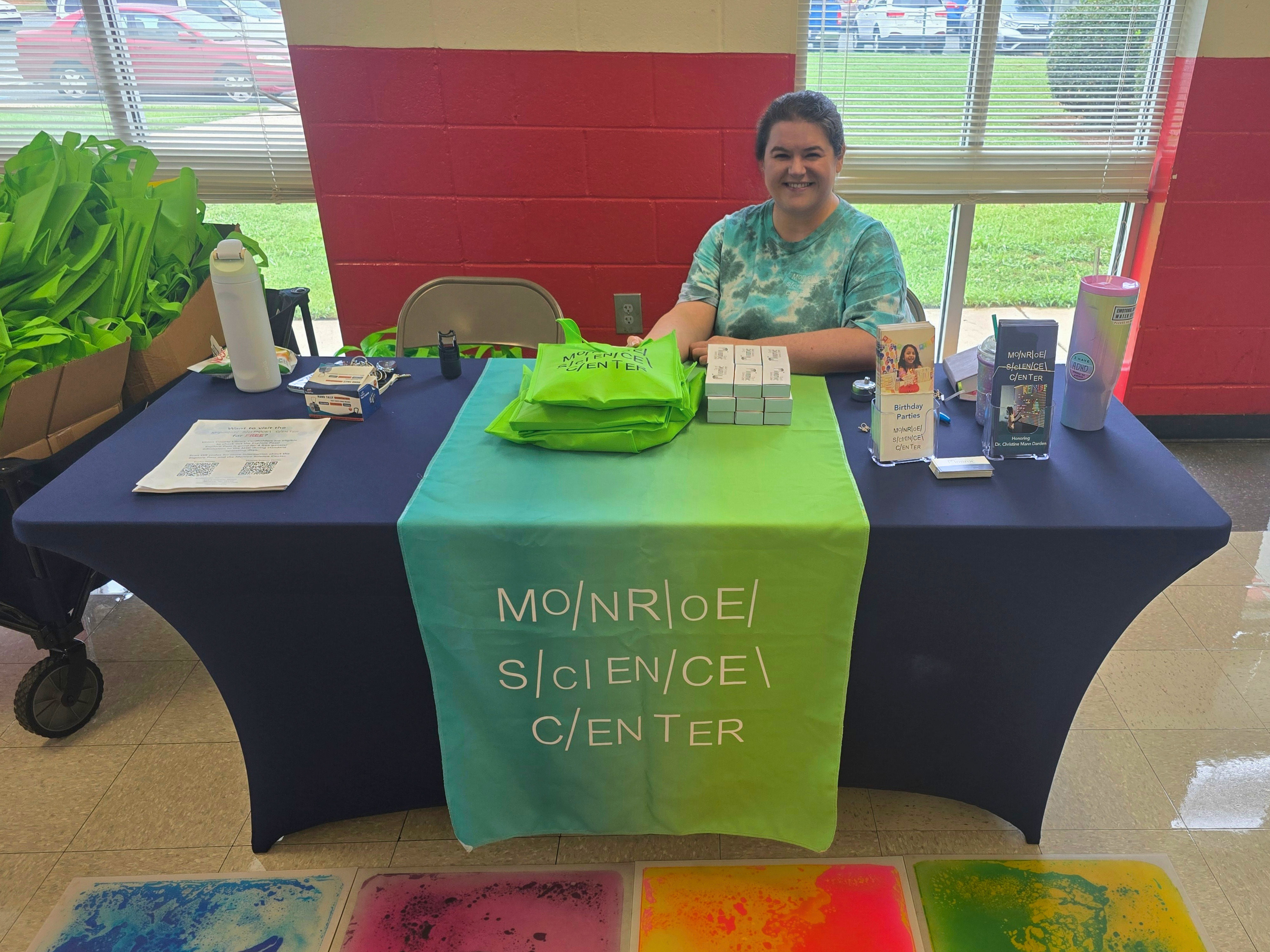 Monroe Science Center staff sit at the information table during Family Fun Fest.
